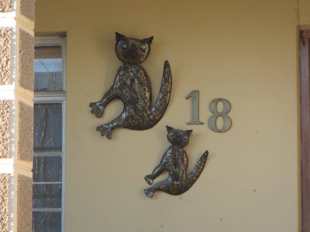 Friendly cat adornments near a door. Sutherland, October 2013. 