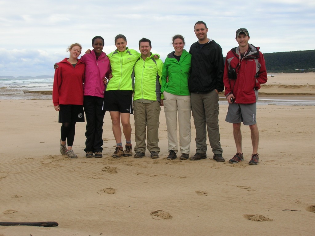 The group on the beach, wearing various bright shades of rain gear (except for Jackie, in boring black). 