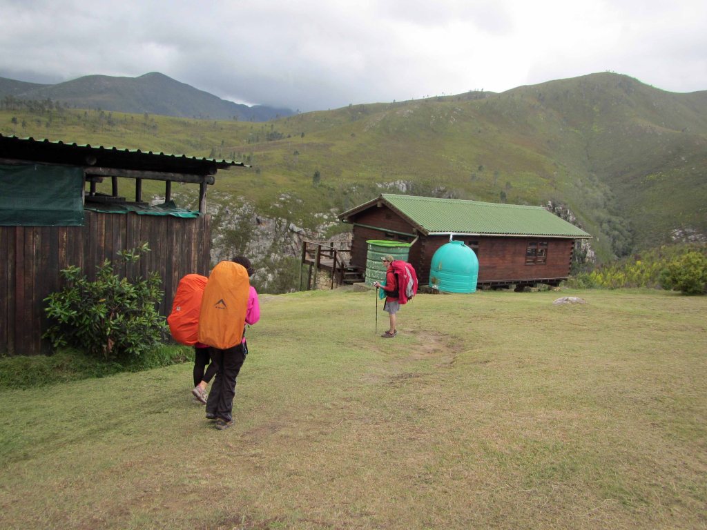 Tired hikers arriving at Blaauwkrans Hut. 