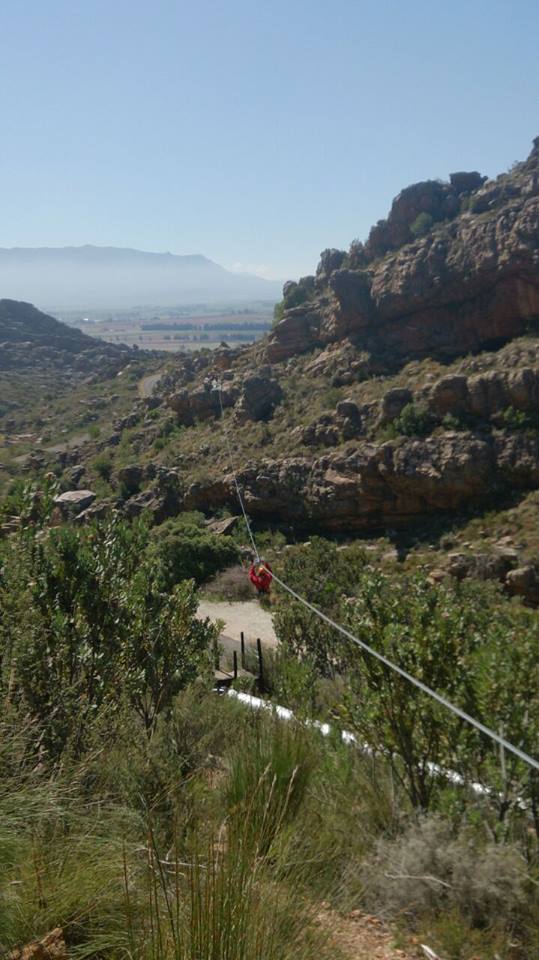 One of my friends on the first zipline. You can see vineyards in the background. 
